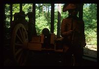 Exhibit with men and a cannon. Color photo. 